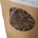 Brown paper bag with a window showing insect larvae  (chicken treats) inside, on a white background.