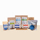 Collection of chicken care products including bags, bowls, and containers on a beige background