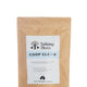 Kraft paper bag with a label for 'Talking Hens Coop Clean' on a white background