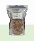 Clear plastic bag with shell grit and a label on a white background